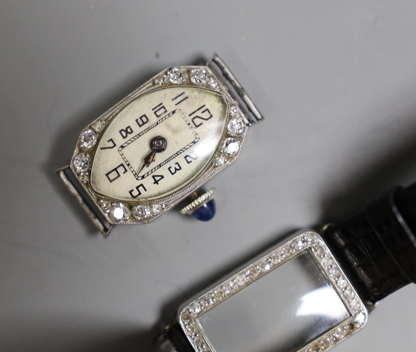 Three assorted mid 20th century white metal and diamond set manual wind cocktail watches, one stamped platinum, (a.f.).
